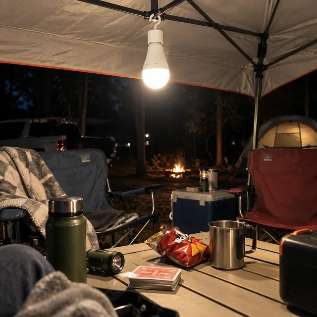 Rechargeable emergency bulb hanging outdoors during camping