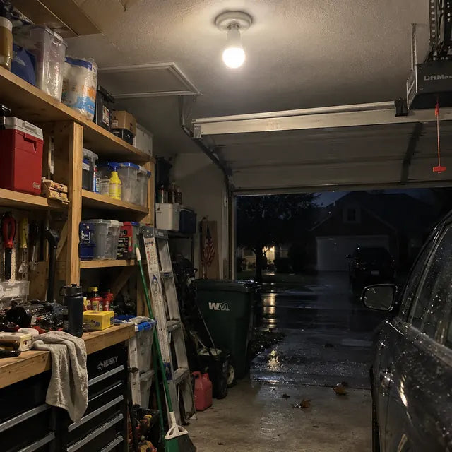Garage lit by an emergency bulb during rainy weather