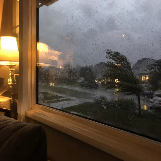 Storm outside a home with warm emergency lighting inside
